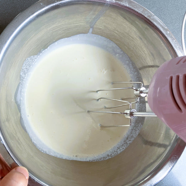 whipping the cream with a hand mixer