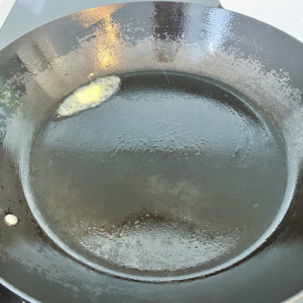 heating the frying pan and adding butter