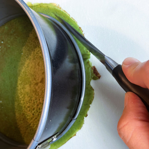 cutting the edges of the crepes using a pairing knife