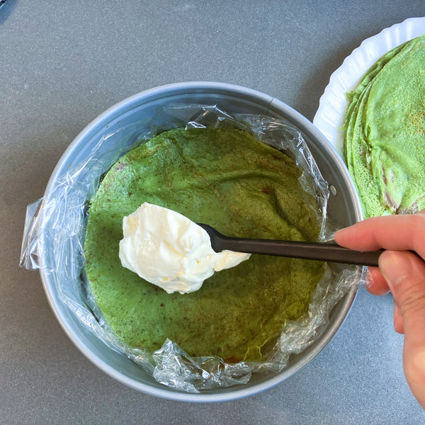 adding a layer of whipped cream