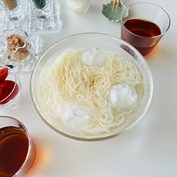 putting the somen noodles in a bowl with ice water