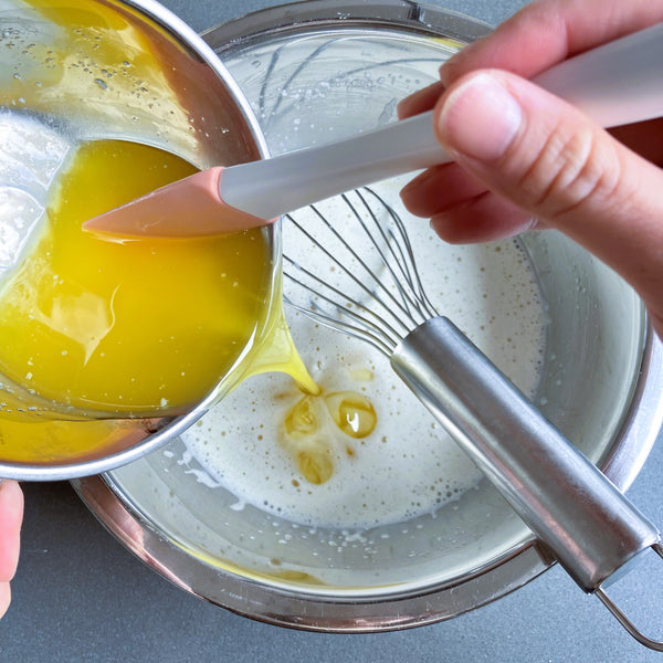adding the melted butter into the wet batter
