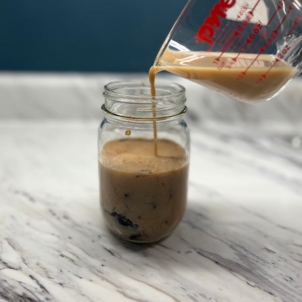 topping the coffee jelly with milk tea