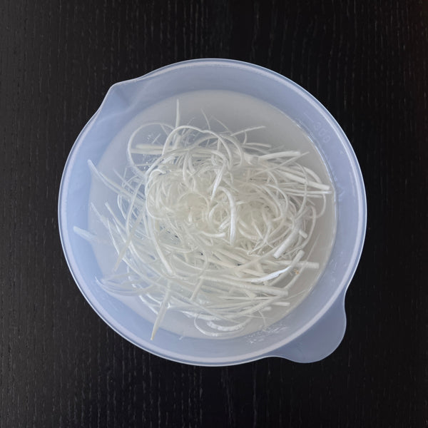 letting the sliced white leek soak in a bowl of water