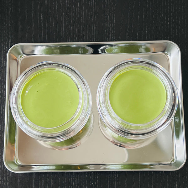 adding the matcha pudding into the jars