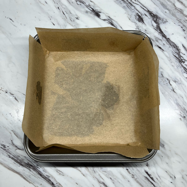 lining a pan with parchment paper