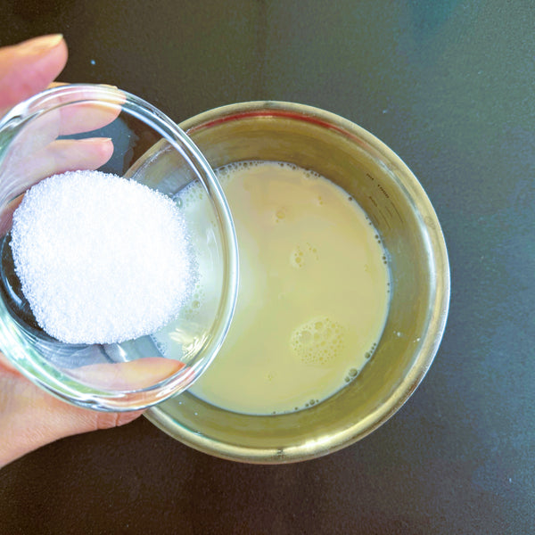 adding sugar to the milk