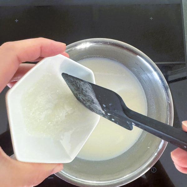 adding the gelatin mixture to the milk mixture