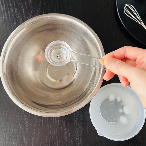 measuring out 5 tbsp of ice water