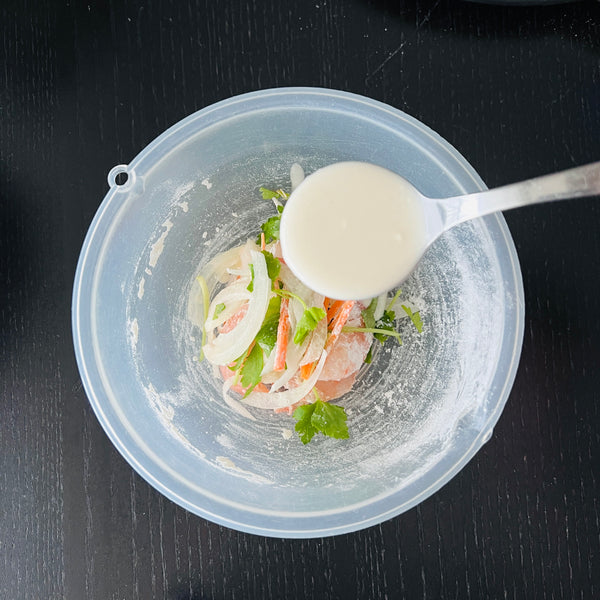 pouring kakiage batter over the ingredients