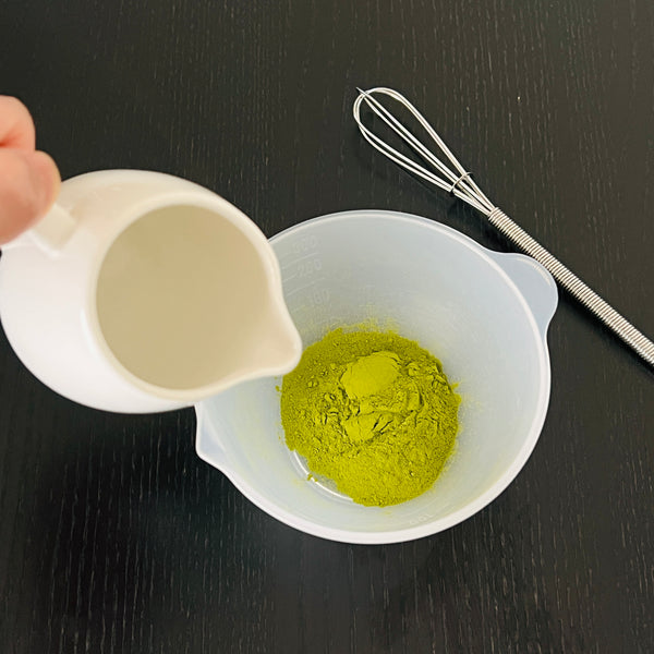 dissolving matcha powder in hot water