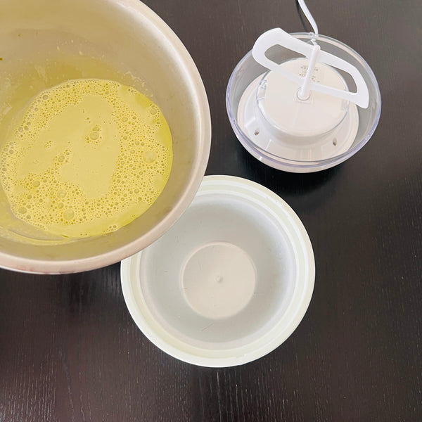 pouring the matcha ice cream mixture into the ice cream maker