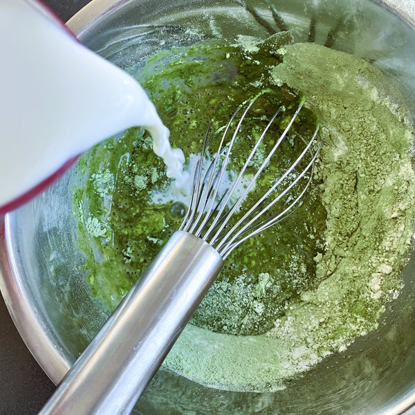 pouring the milk into the crepe batter