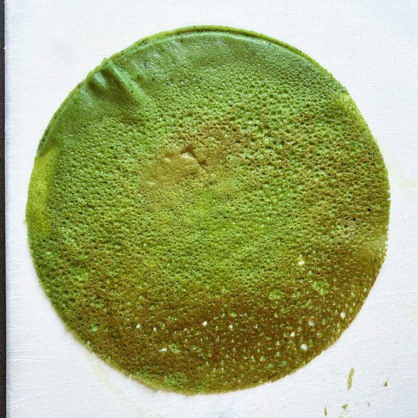 stacking the matcha crepes on top of each other