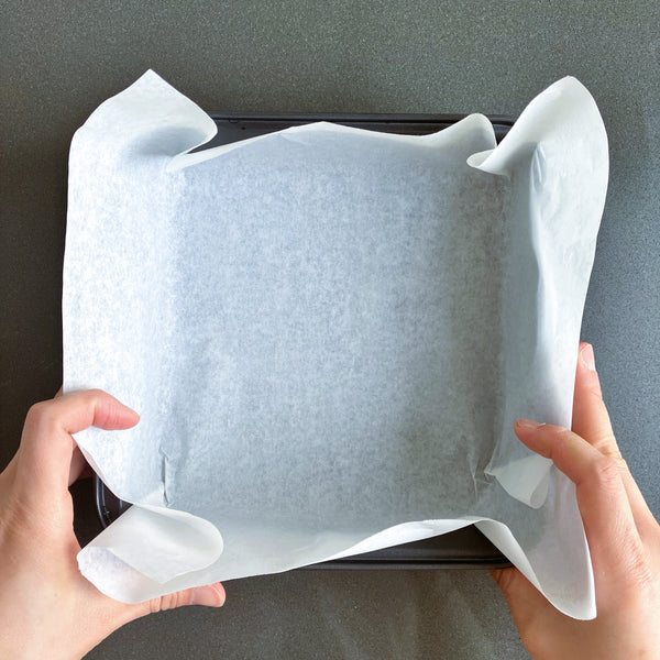 lining a pan with parchment paper