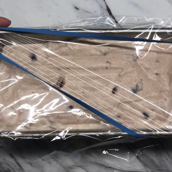 placing a piece of plastic wrap over the container and then freezing the red bean ice cream