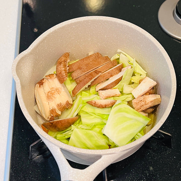 adding the shiitake mushrooms and cabbage