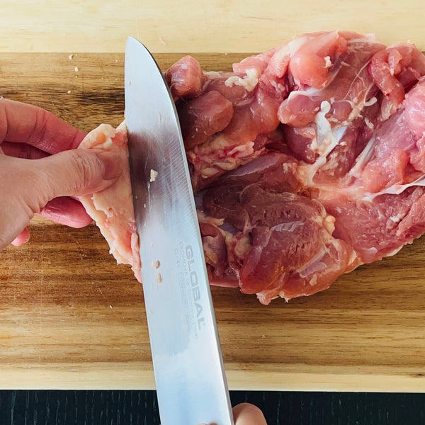 cutting excess skin off of the chicken