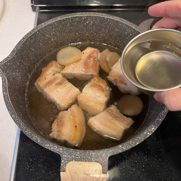 adding the seasonings to the buta no kakuni