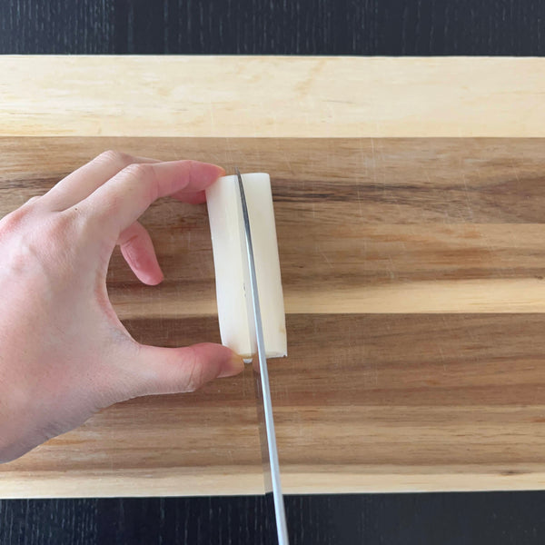 slicing the white part of the leek in half