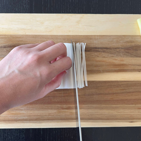 slicing the white part of the leek into thin strips