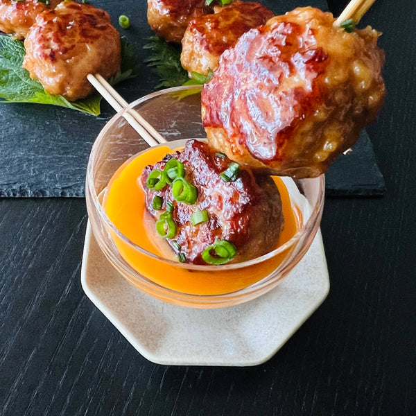 dipping tsukune in egg yolk